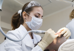 A dentist giving sedation to the patient