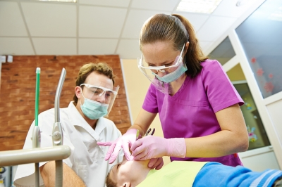 Dentist Treatming Sedated Child Patient