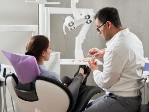 dentist with patient in exam chair 
