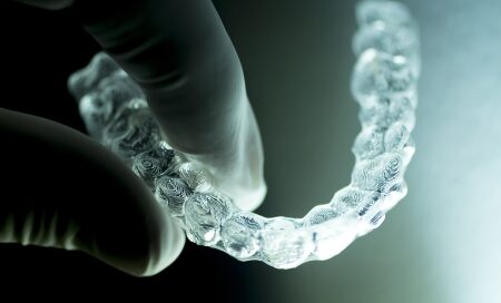 A Man holding Aligners