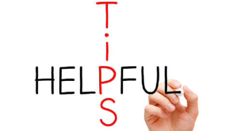 A hand is writing the word "TIPS" in red vertically, intersecting the word "HELPFUL" in black horizontally.