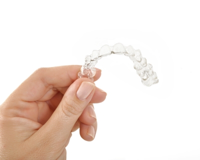 A man holding Invisalign