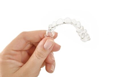 A man holding Invisalign